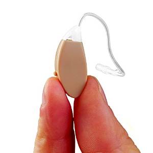 Close up of two fingers holding a small hearing aid